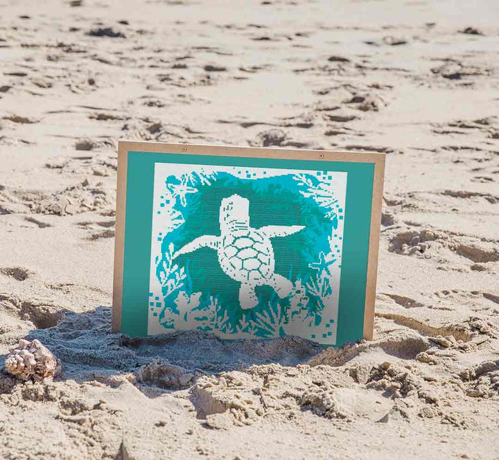 Stitched and framed preview of Turtle At Sea Counted Cross Stitch Pattern and Kit