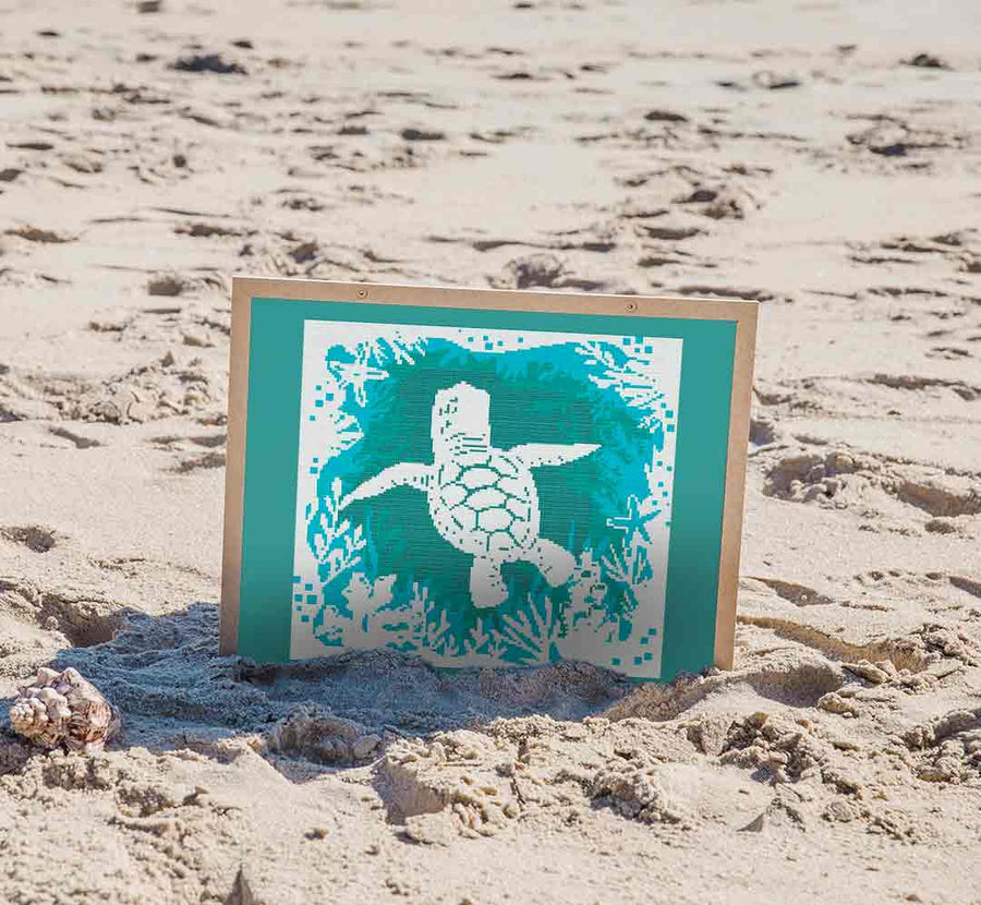 Stitched and framed preview of Turtle At Sea Counted Cross Stitch Pattern and Kit
