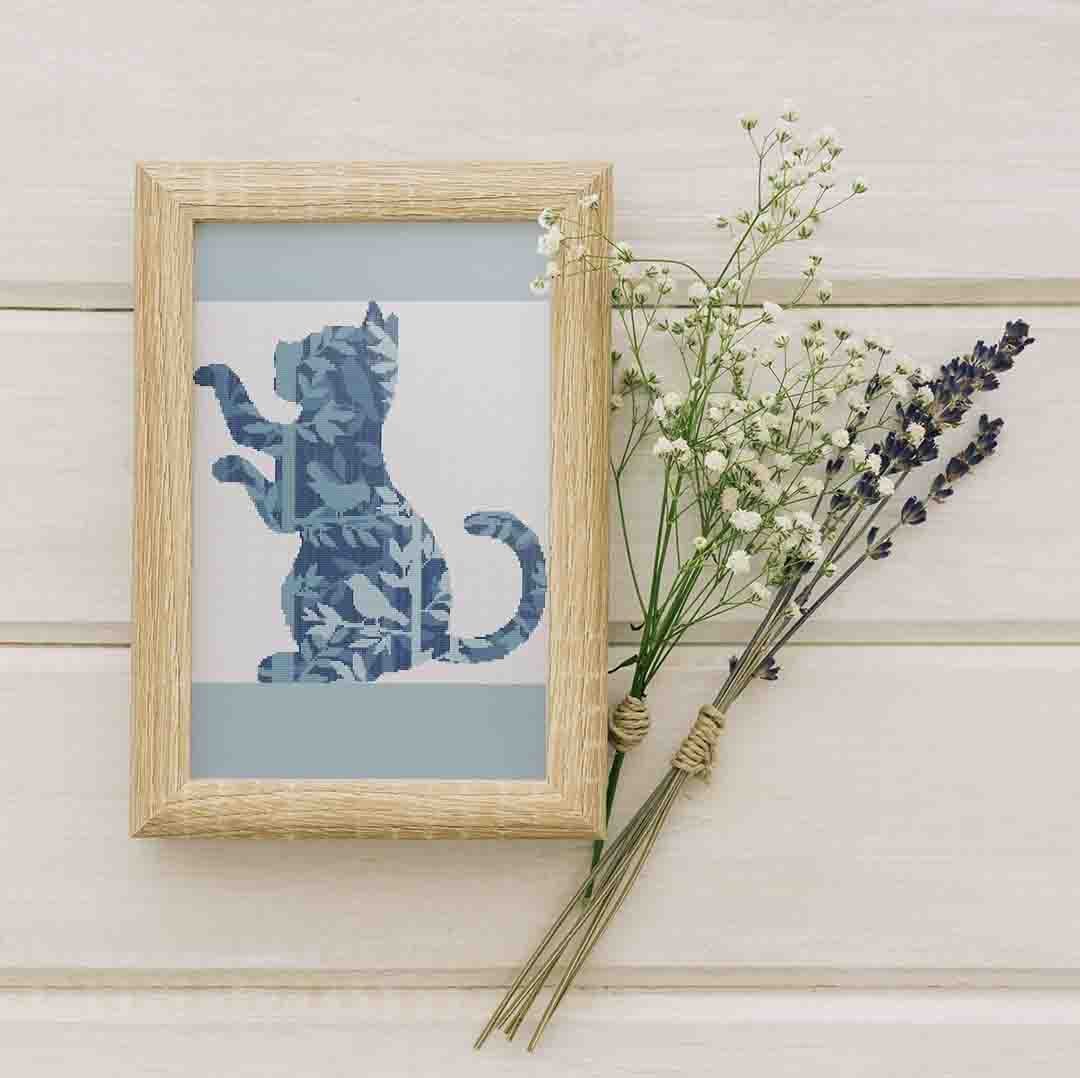 Stitched and framed preview of Birds And A Kitten Counted Cross Stitch Pattern and Kit