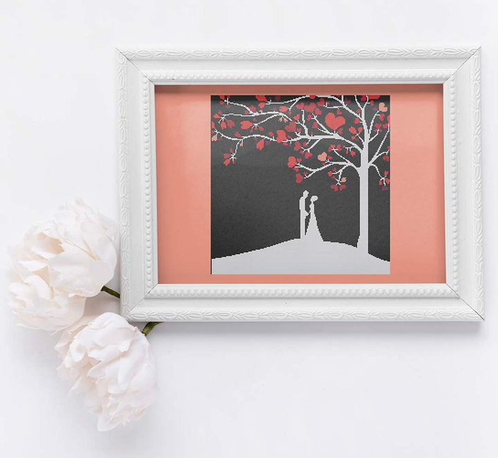 Stitched and framed preview of Kiss Goodnight Counted Cross Stitch Pattern and Kit