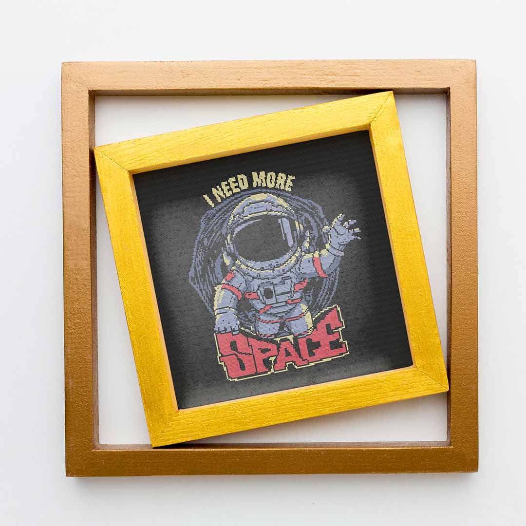 Stitched and framed preview of Need More Space Counted Cross Stitch Patten and Kit