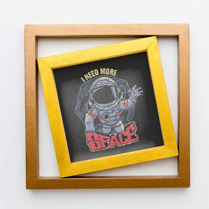 Stitched and framed preview of Need More Space Counted Cross Stitch Patten and Kit