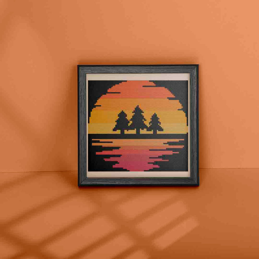 An image of a stitched and framed preview of "3 Pines" a counted cross stitch pattern and kit by Stitch Wit
