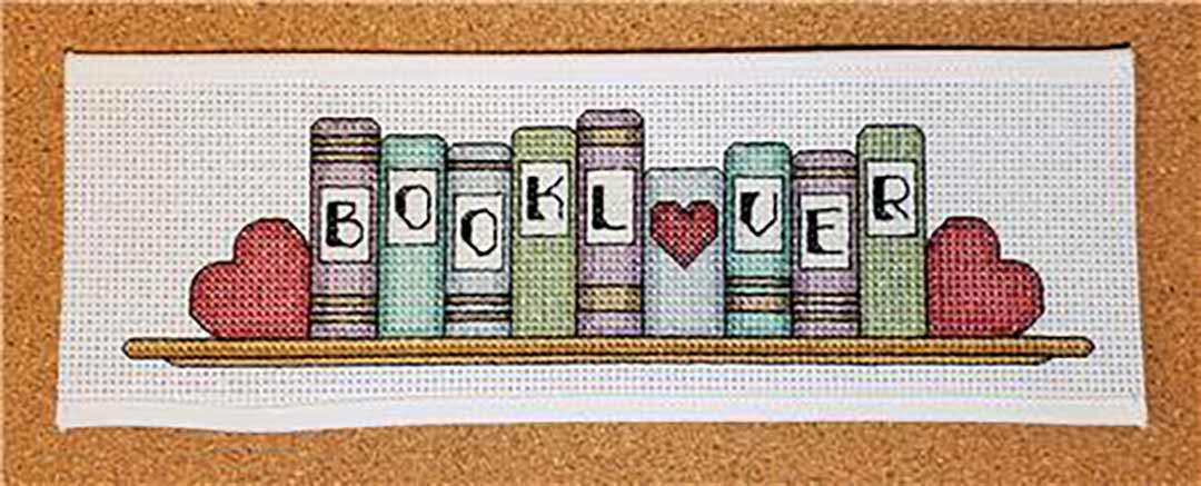 A stitched preview of the counted cross stitch pattern Book Lover by Rogue Stitchery