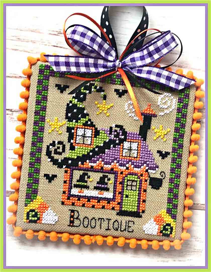A stitched preview of the counted cross stitch pattern Booville Boutique by Sugar Stitches Design