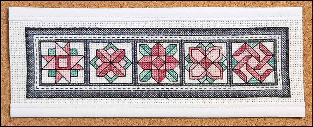 A stitched preview of the counted cross stitch pattern Carnations Bookmark by Rogue Stitchery