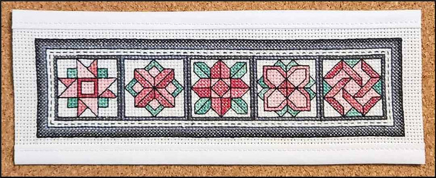 A stitched preview of the counted cross stitch pattern Carnations Bookmark by Rogue Stitchery