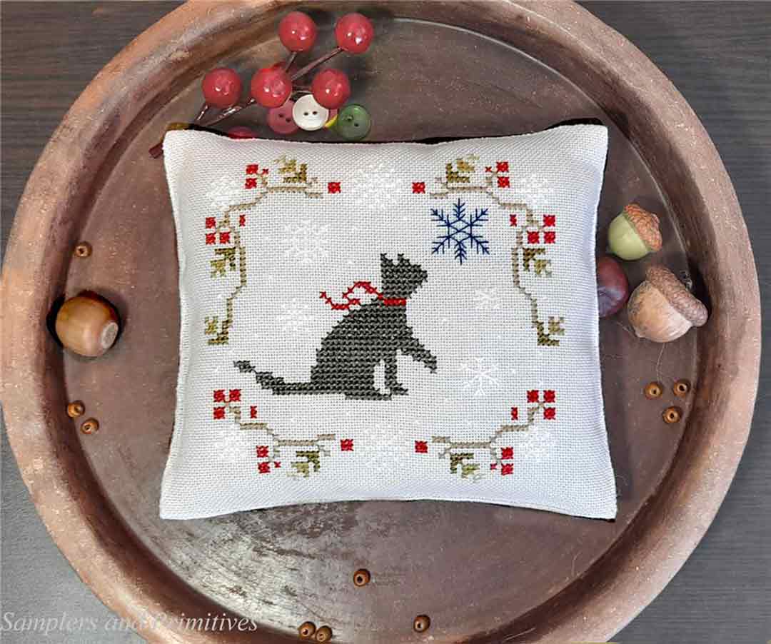 A stitched preview of the counted cross stitch pattern Cat And Snowflakes by Samplers and Primitives