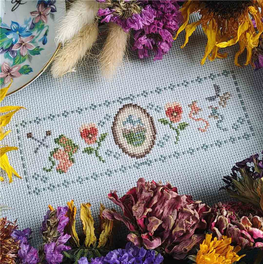 A stitched preview of the counted cross stitch pattern Cozy Cottage Comforts by StitchSprout