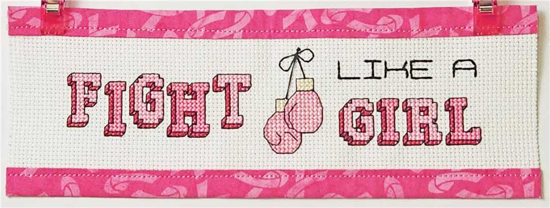 A stitched preview of the counted cross stitch pattern Fight Like A Girl by Rogue Stitchery