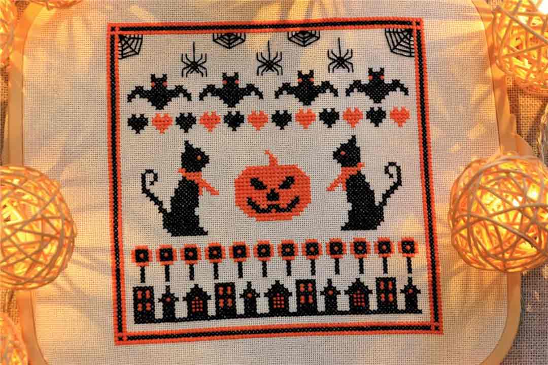 A stitched preview of the counted cross stitch pattern Halloween Sampler by Kate Spiridonova