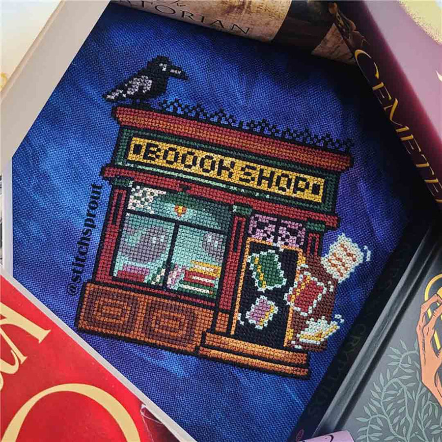 A stitched preview of the counted cross stitch pattern Haunted Bookshop by StitchSprout