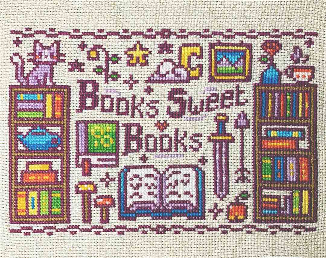 A stitched preview of the counted cross stitch pattern Home Is Where The Books Are by Flossy Fox Shop