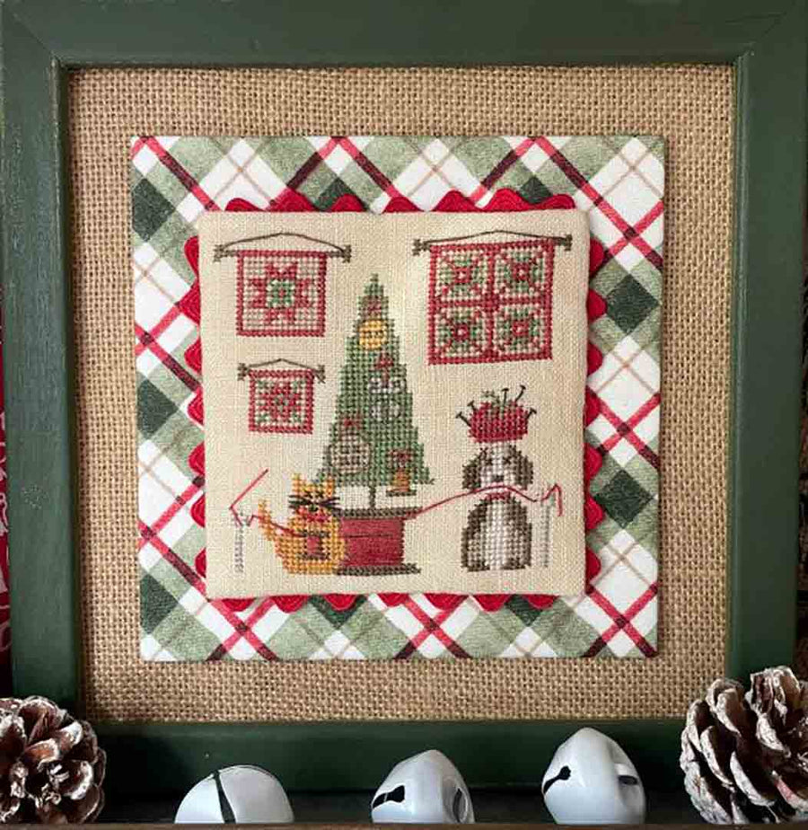 A stitched preview of the counted cross stitch pattern Paws Under The Tree by Mani di Donna Design