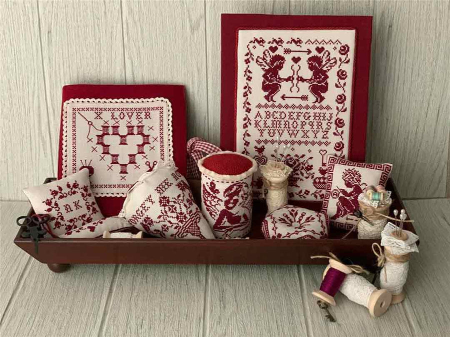 A stitched preview of the counted cross stitch patterns Red Smalls 2024 by Twin Peak Primitives