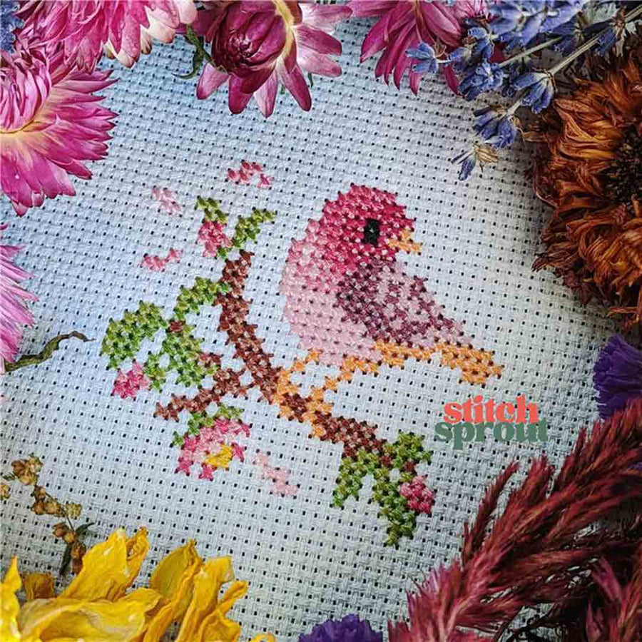 A stitched preview of the counted cross stitch pattern Rose Finch On Cherry Blossom by StitchSprout