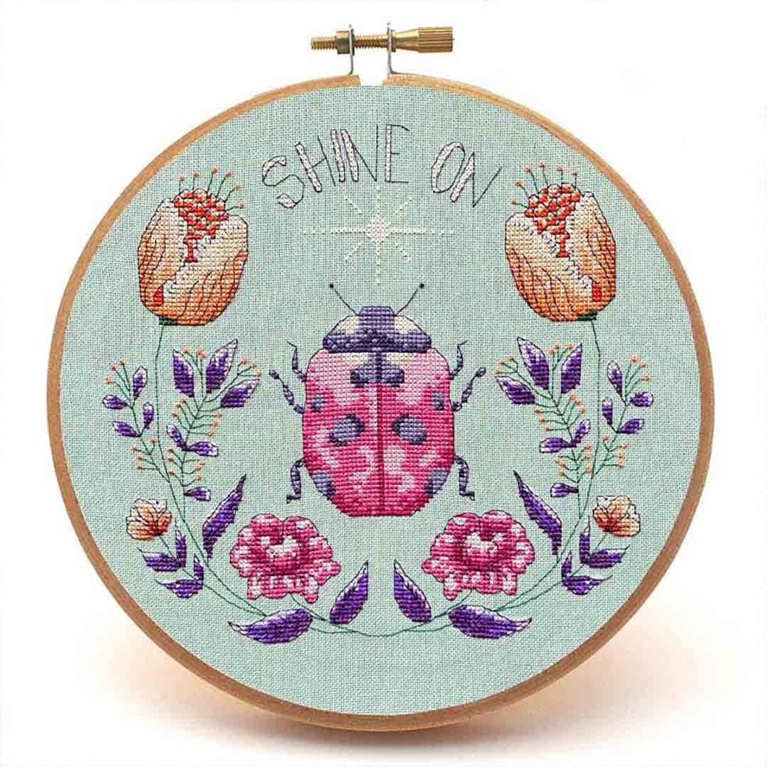 A stitched preview of the counted cross stitch pattern Shine On by Peacock & Fig