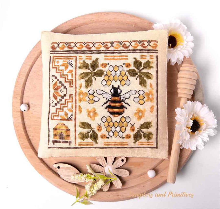 A stitched preview of the counted cross stitch pattern The Bee Quaker II by Samplers and Primitives