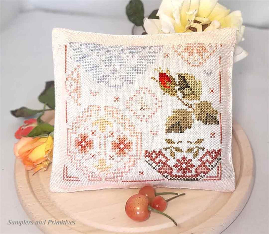A stitched preview of the counted cross stitch pattern The Rose Quaker by Samplers and Primitives