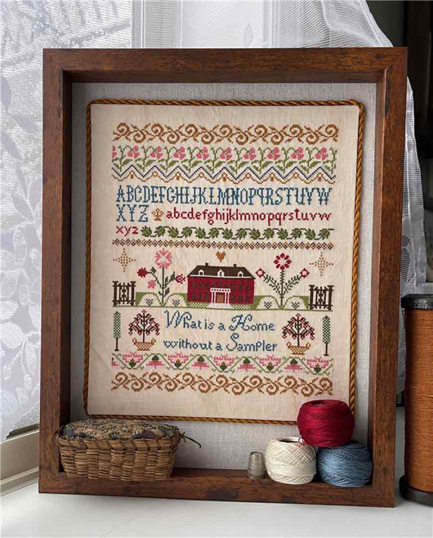 A stitched preview of the counted cross stitch pattern What Is A Home by Jan Hicks Creates