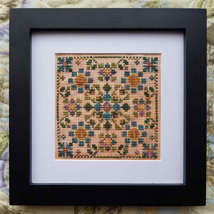 A stitched view of the counted cross stitch pattern Where The Fae Play by Carolyn Manning Designs
