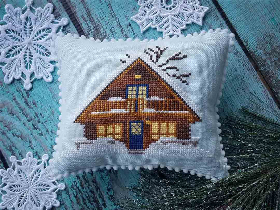 A stitched preview of the counted cross stitch pattern Winter Cabin by KEB Studio Creations