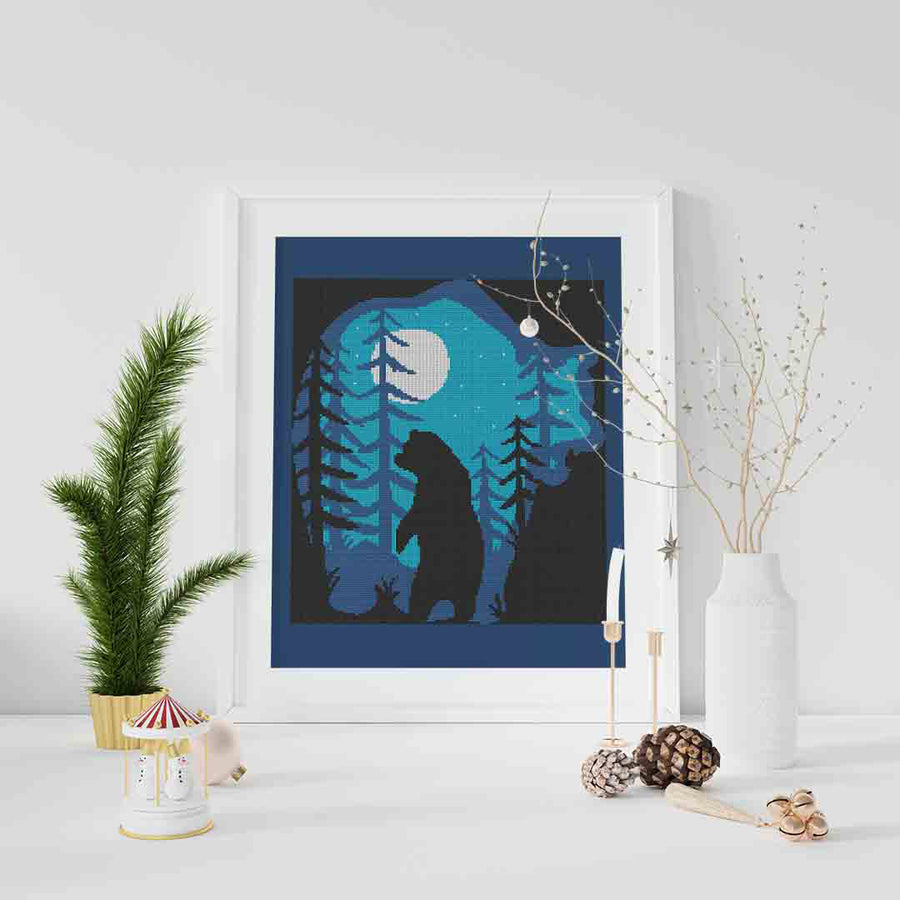 A stitched and framed preview of the counted cross stitch pattern A Bear's Blue Night by Stitch Wit