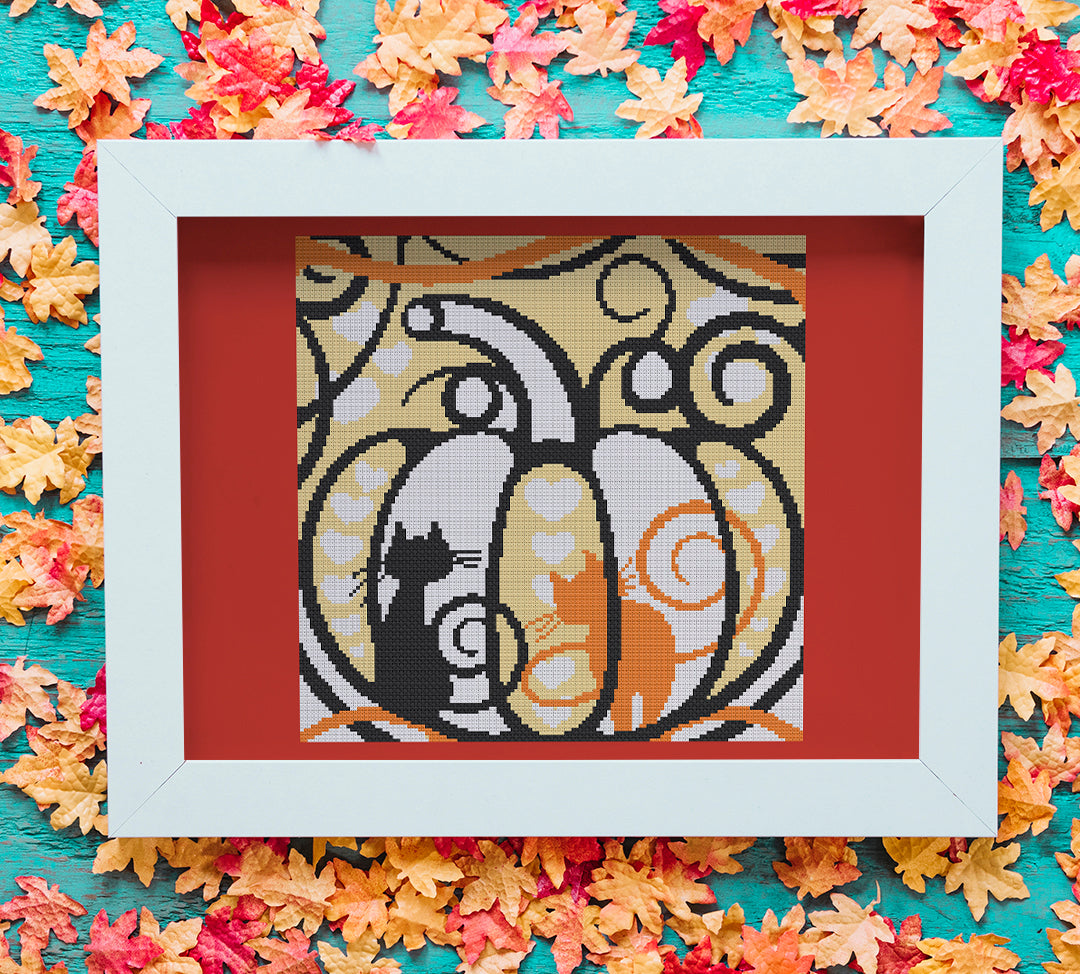 Stitched and framed preview of Cats In A Pumpkin Counted Cross Stitch Pattern and Kit