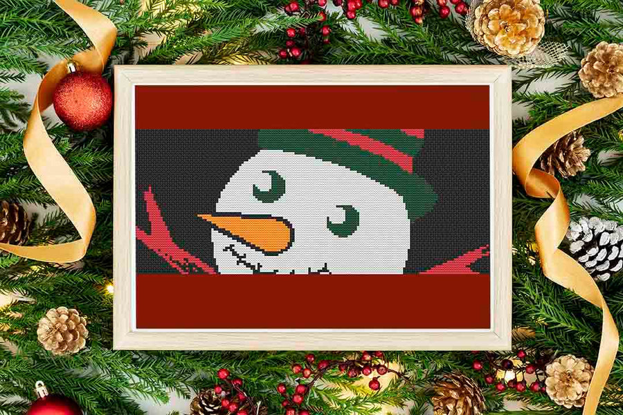 A stitched and framed preview of the counted cross stitch pattern Christmas Eyes: Counted Cross Stitch Pattern and Kit