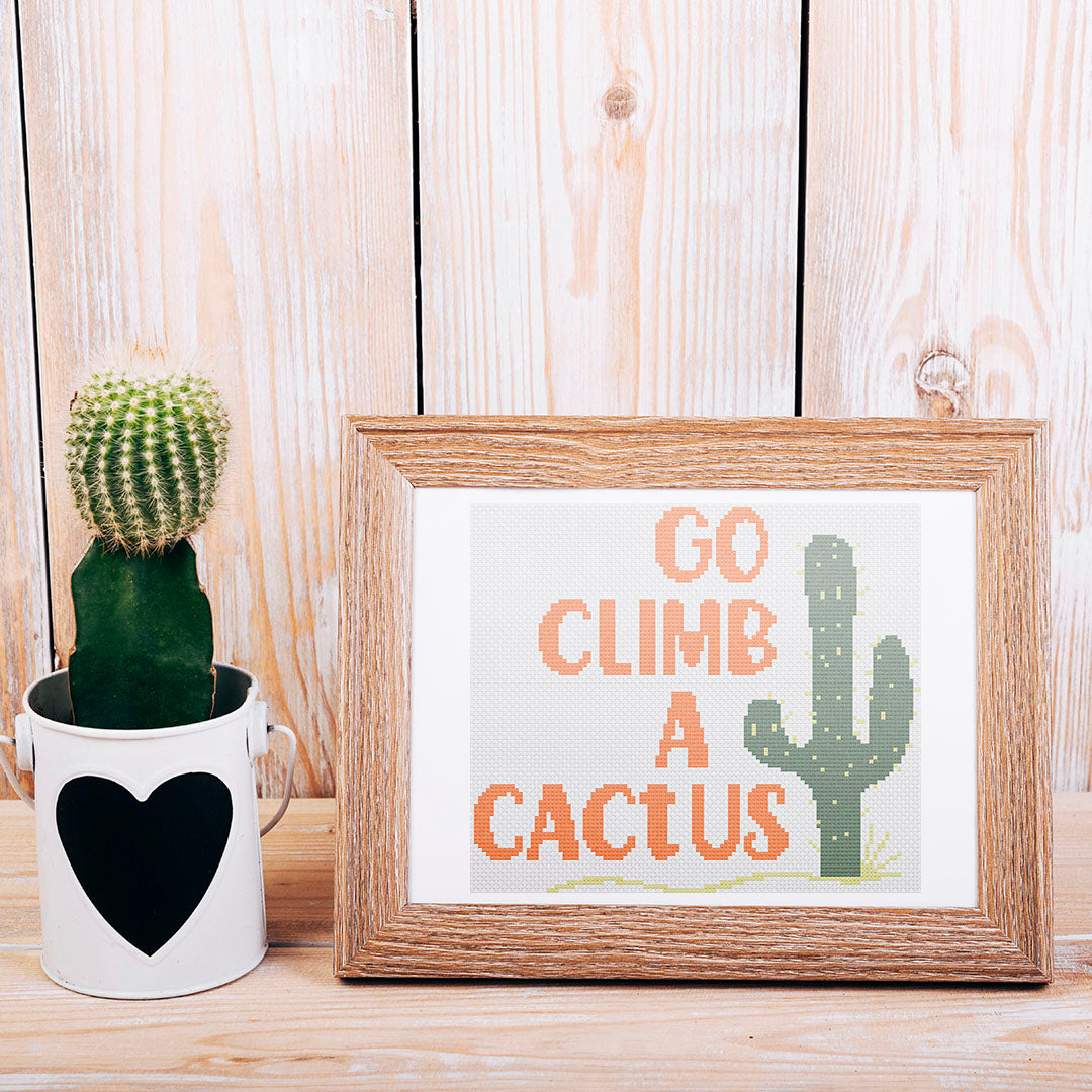 A stitched preview of the counted cross stitch pattern Climb A Cactus: Counted Cross Stitch Pattern and Kit
