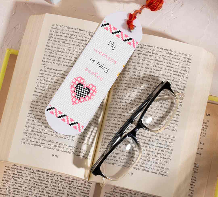 A stitched preview of the counted cross stitch pattern "Fully Booked" by Stitch Wit