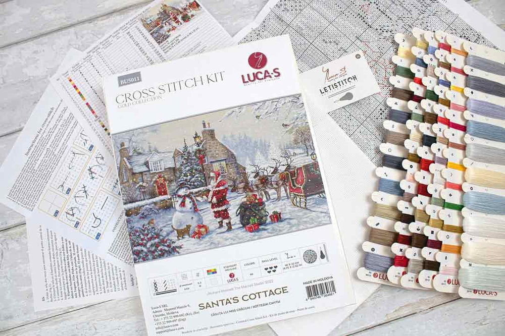 All the supplies included with Santa's Cottage Counted Cross Stitch Kit