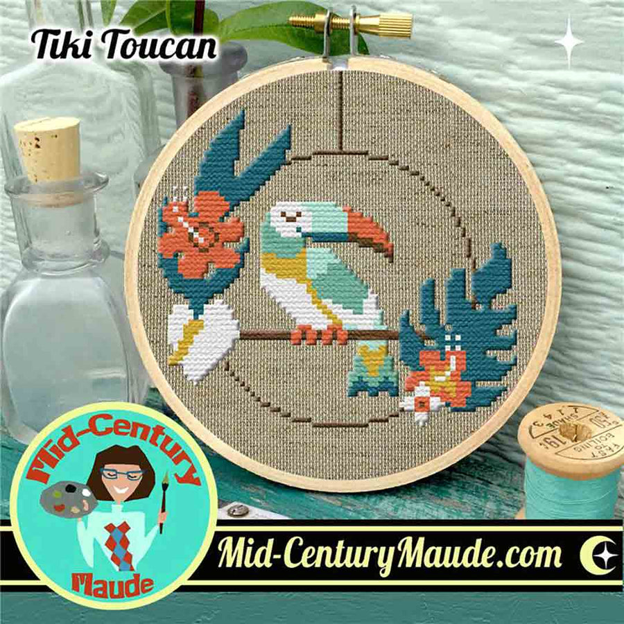 A stitched preview of the counted cross stitch pattern Tiki Toucan by Mid-Century Maude