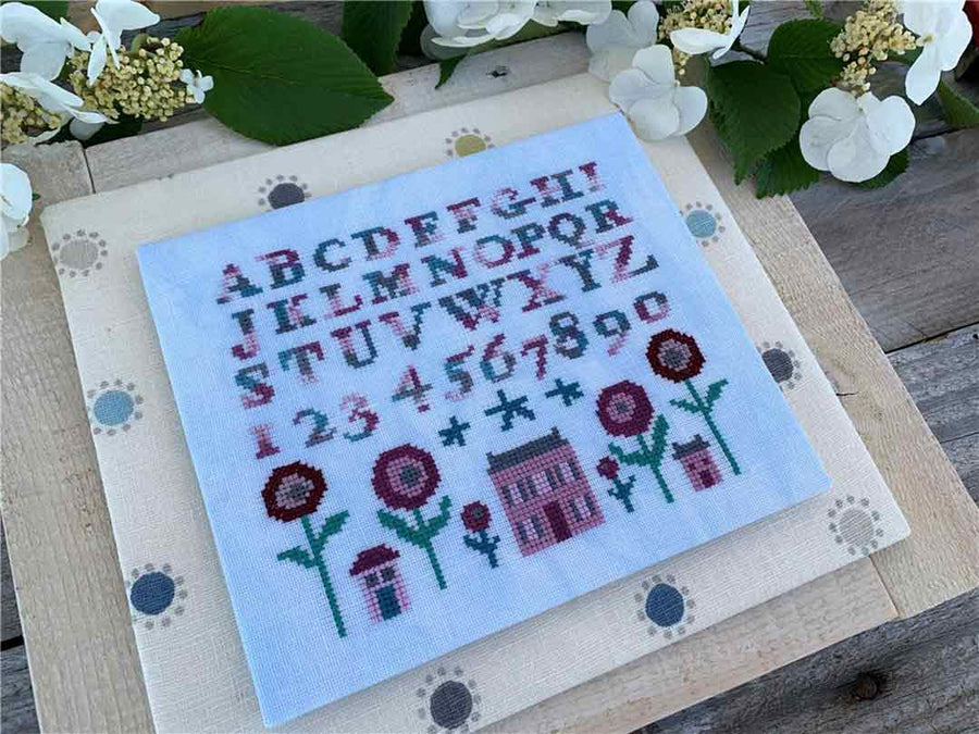 A stitched preview of the counted cross stitch pattern Venice Poppy House by Ardith Design