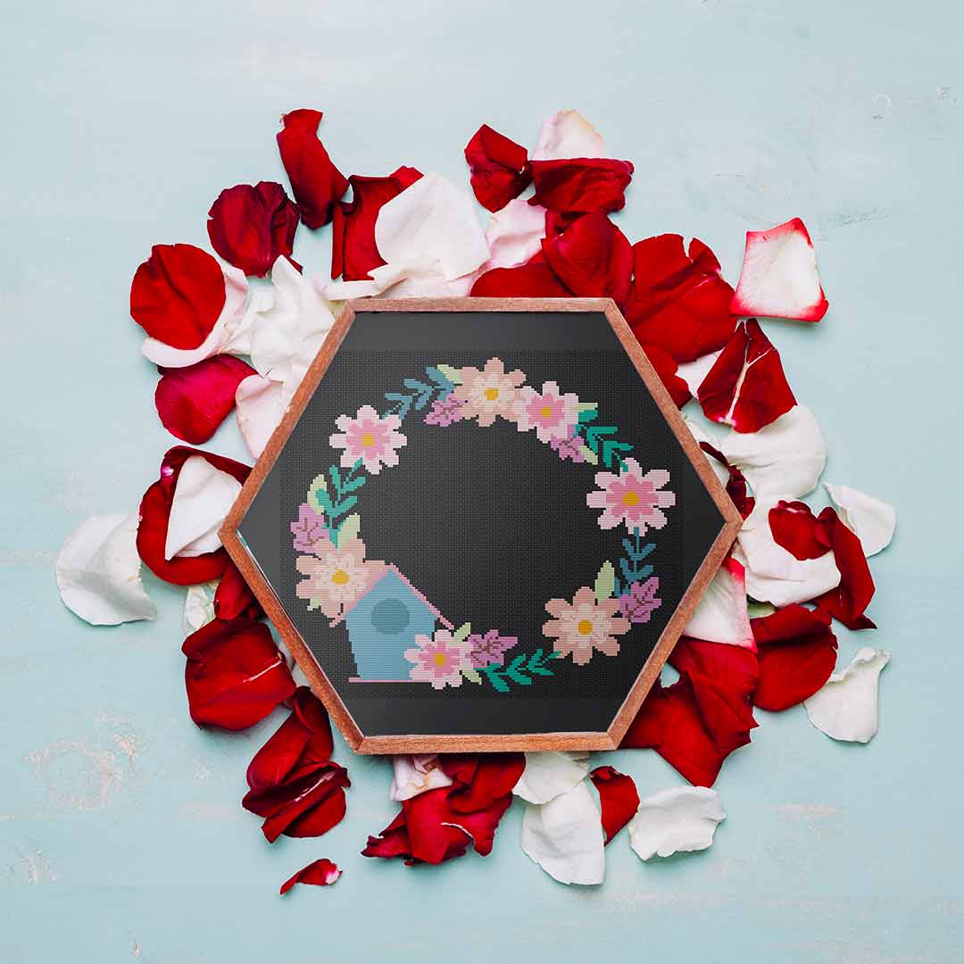 Stitched and framed preview of Birdhouse and Flowers Counted Cross Stitch Pattern and Kit