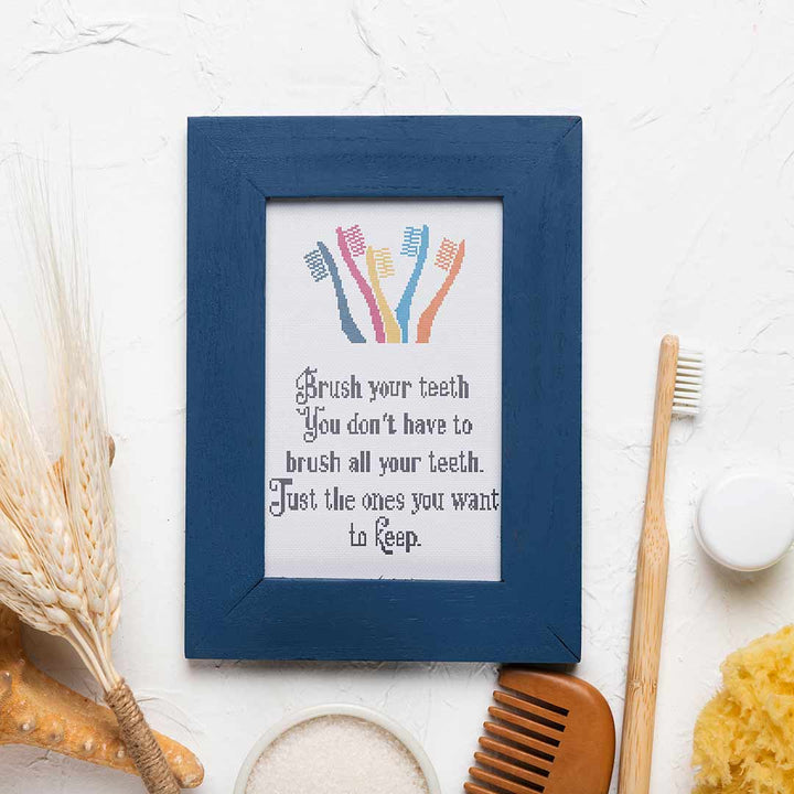 Stitched and framed preview of Brush Your Teeth Counted Cross Stitch Pattern and Kit