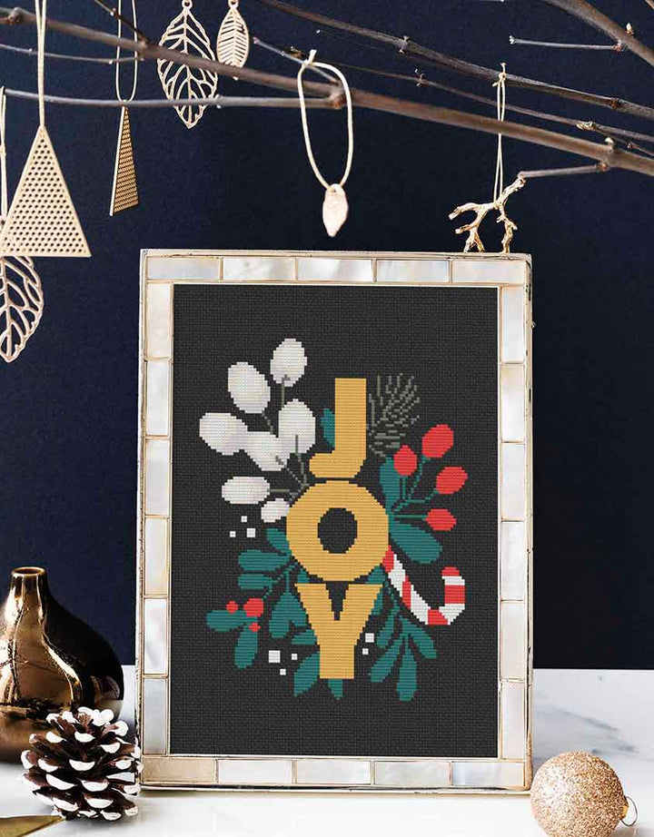 Stitched and framed preview of Joy Counted Cross Stitch Pattern and Kit