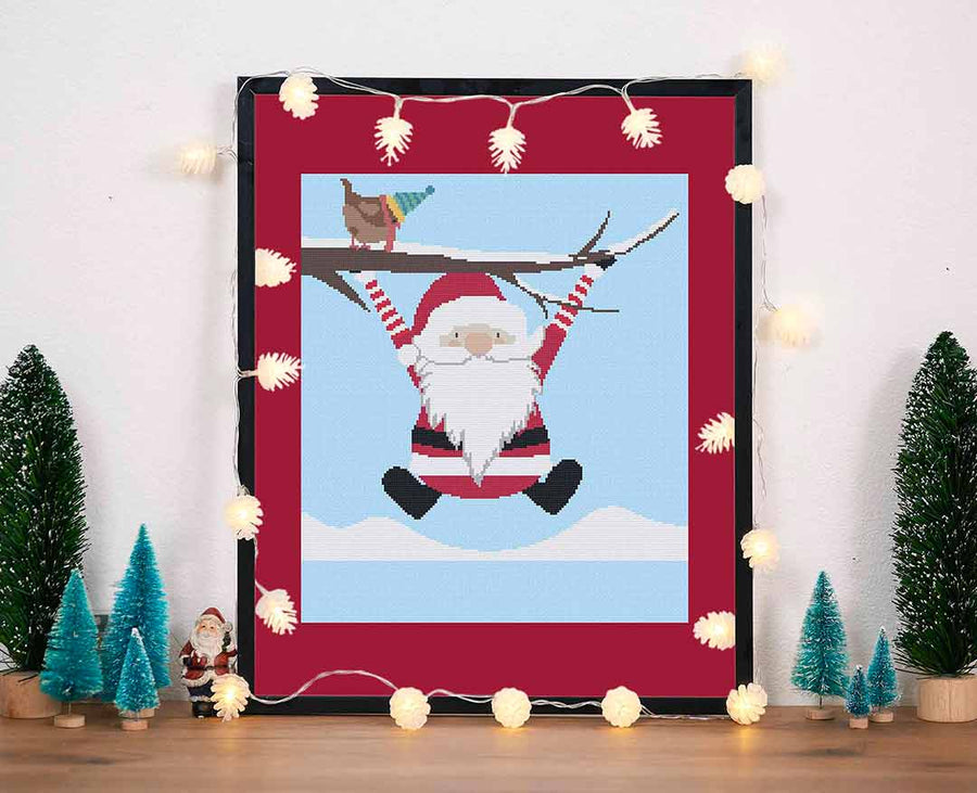 Stitched and framed preview of Santa Plays Counted Cross Stitch Pattern and Kit