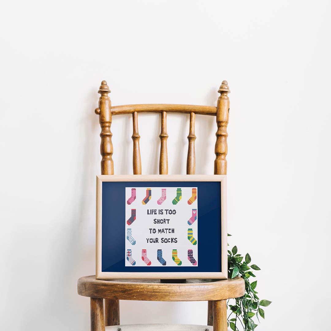 Stitched and framed preview of Socks Counted Cross Stitch Pattern and Kit