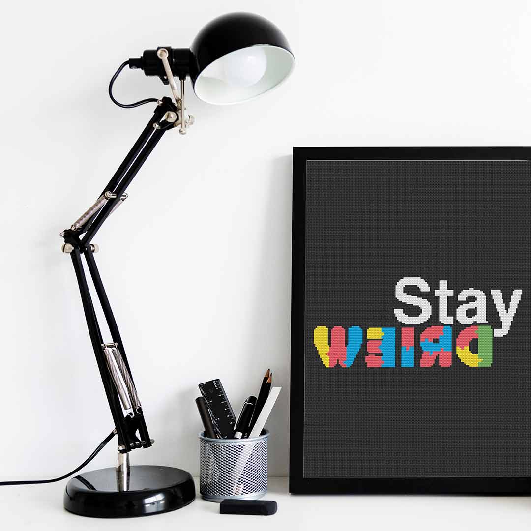 Stitched and framed preview of Stay Weird Counted Cross Stitch Pattern and Kit