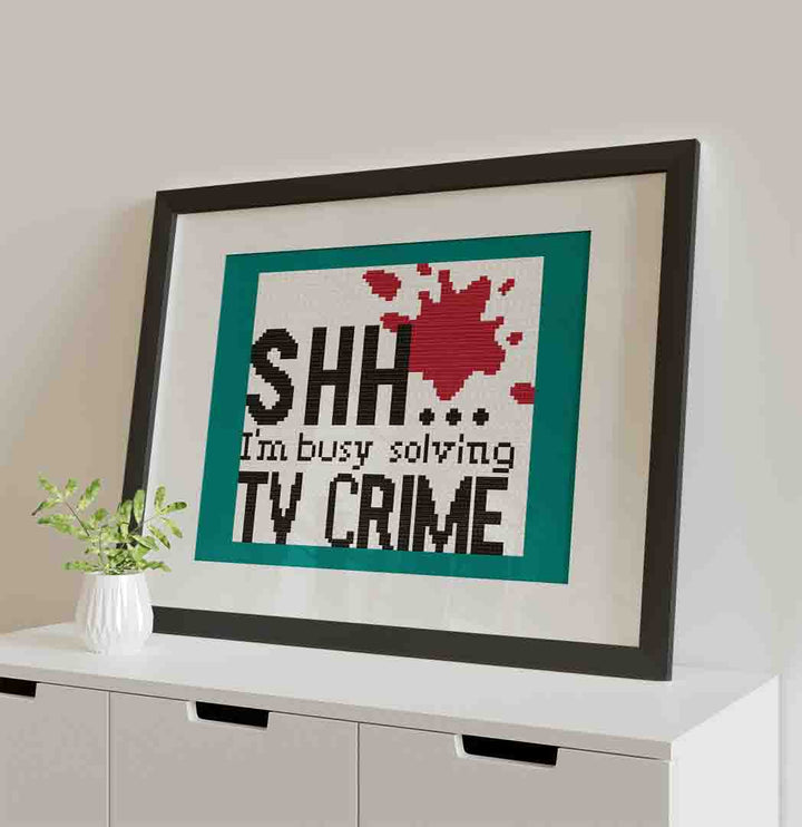 Stitched and framed preview of TV Crime Counted Cross Stitch Pattern and Kit
