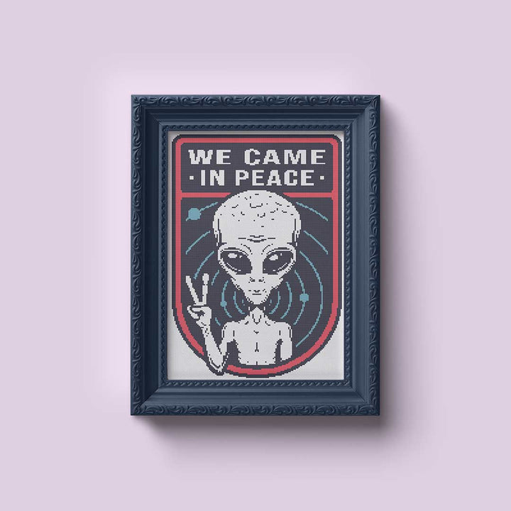 Stitched and framed preview of We Came In Peace Counted Cross Stitch Pattern and Kit